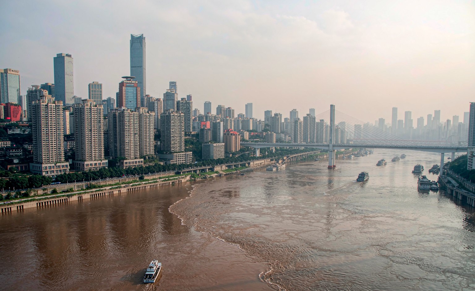 The two-tone confluence of the Jialing and Yangtze rivers at Chaotianmen, skyline behind